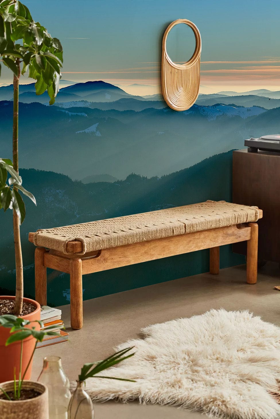 Serene Mountain Ridge mist mural wallpaper with rattan bench, shaggy rug, natural decor in living room.