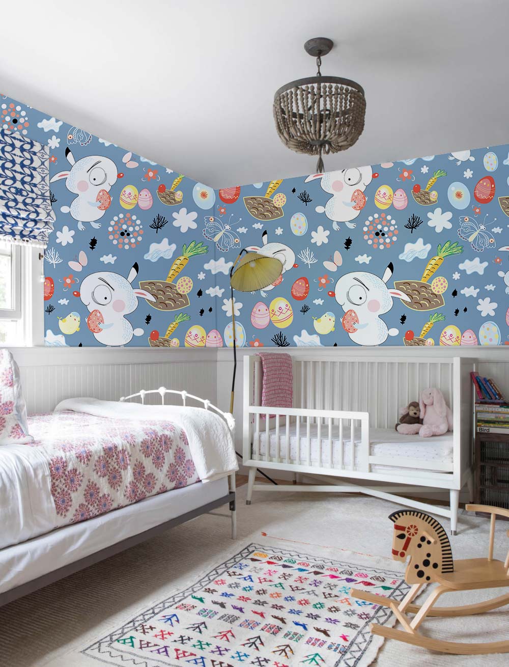 Whimsical Easter Bunny Wallpaper in blue children's room, featuring crib, bed, playful rug, rocking horse.
