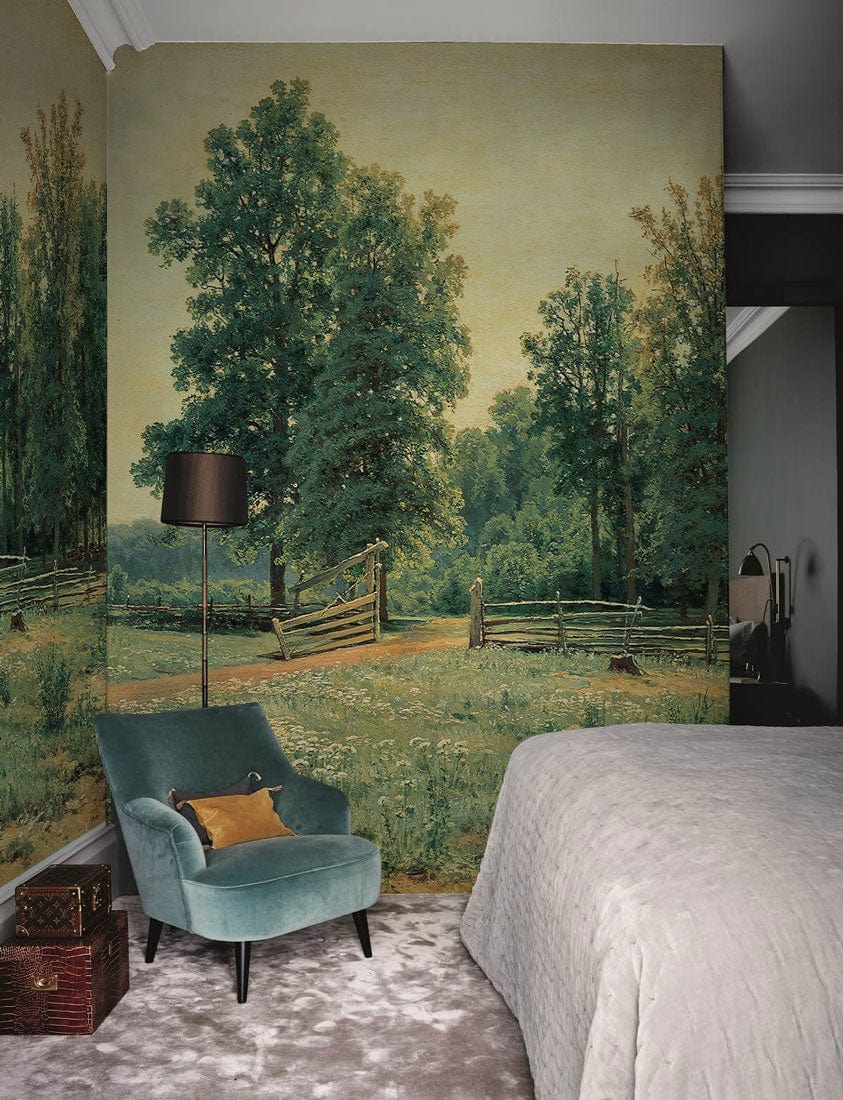 Tranquil Countryside Landscape Wallpaper in bedroom with velvet armchair, grey bedspread, and carpet flooring.