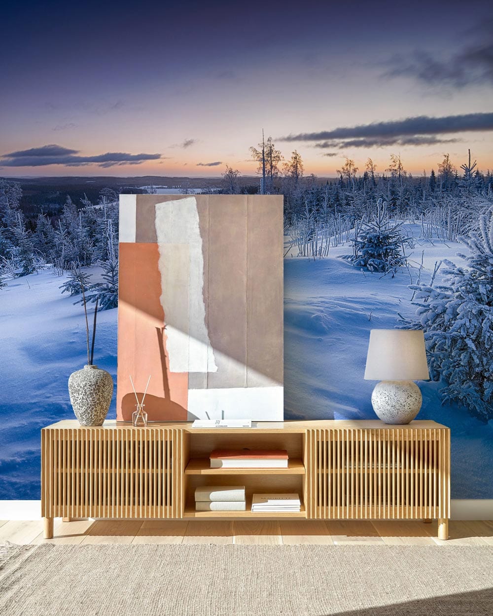Majestic Winter Wonderland Landscape Mural Wallpaper, icy blue tones, wooden sideboard, lamp, canvas, rug.
