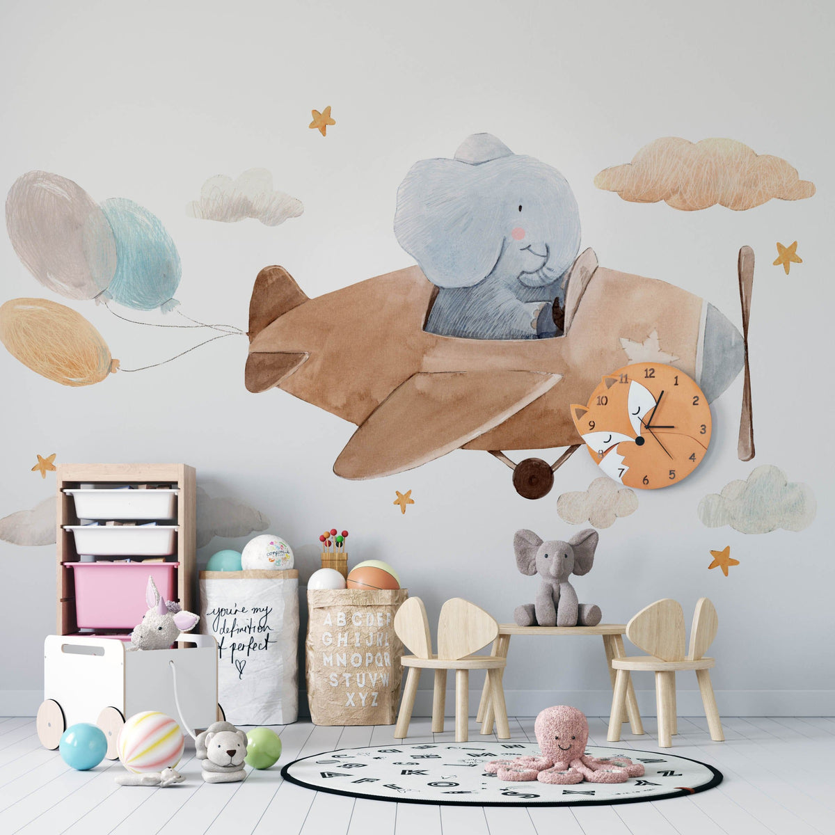 Charming Elephant Adventure mural in nursery, featuring wooden toys, pastel decor, and light wooden flooring.