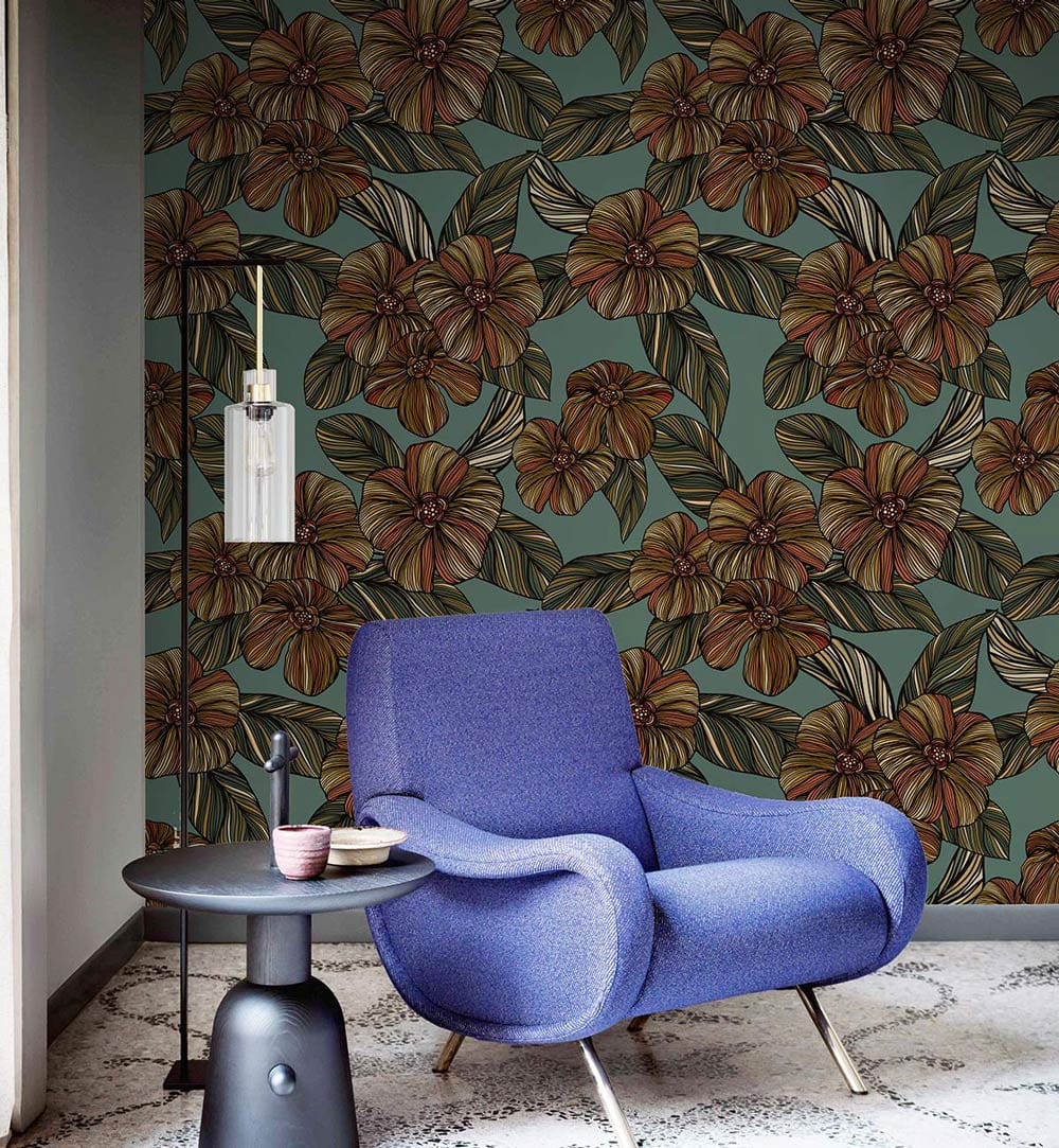 Vintage botanical floral wallpaper in earthy tones, blue armchair, mosaic flooring, modern pendant light.