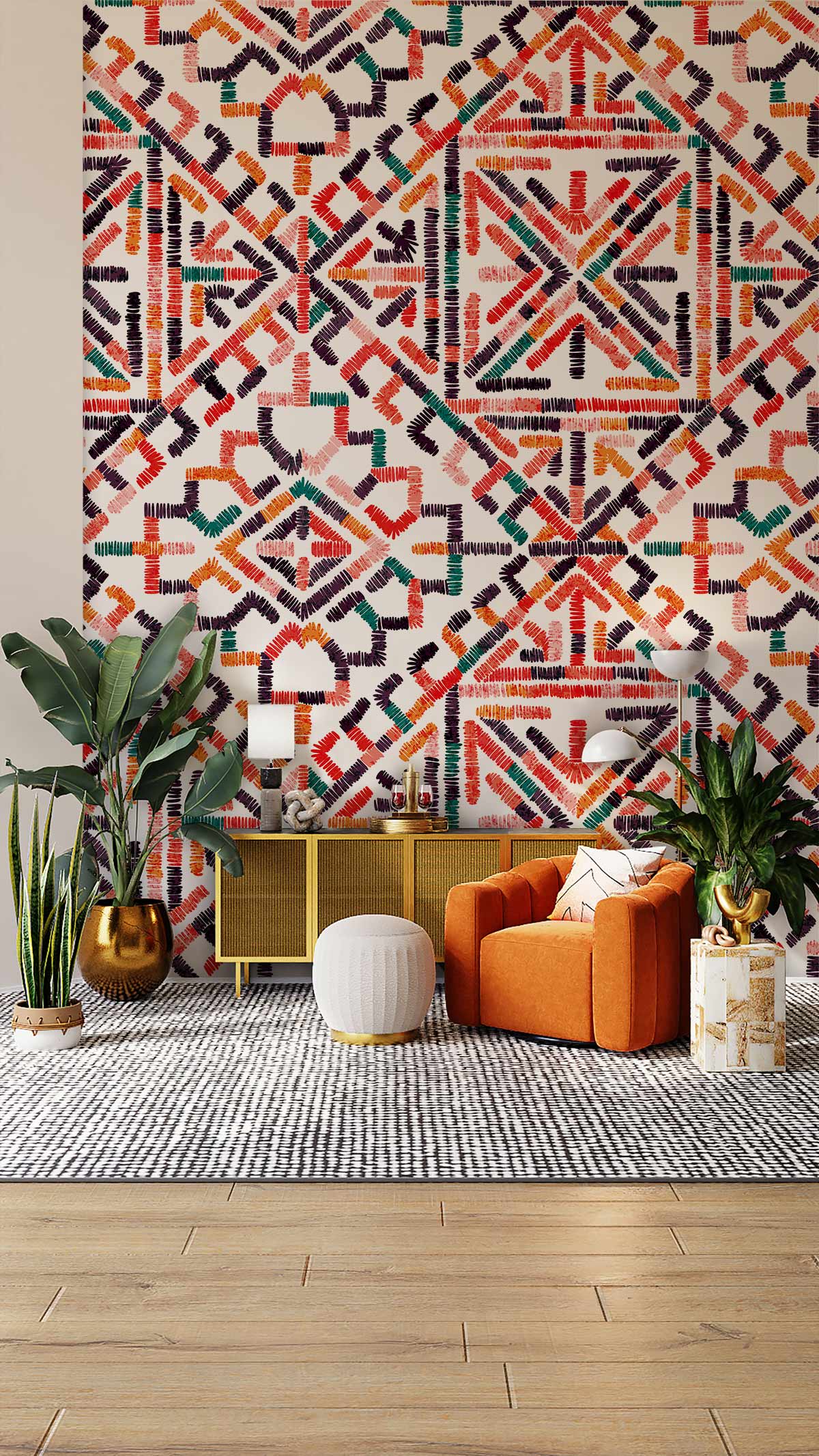 Vibrant geometric bohemian multicolour ethnic wallpaper with orange sofa, wooden floor, and plants in room.