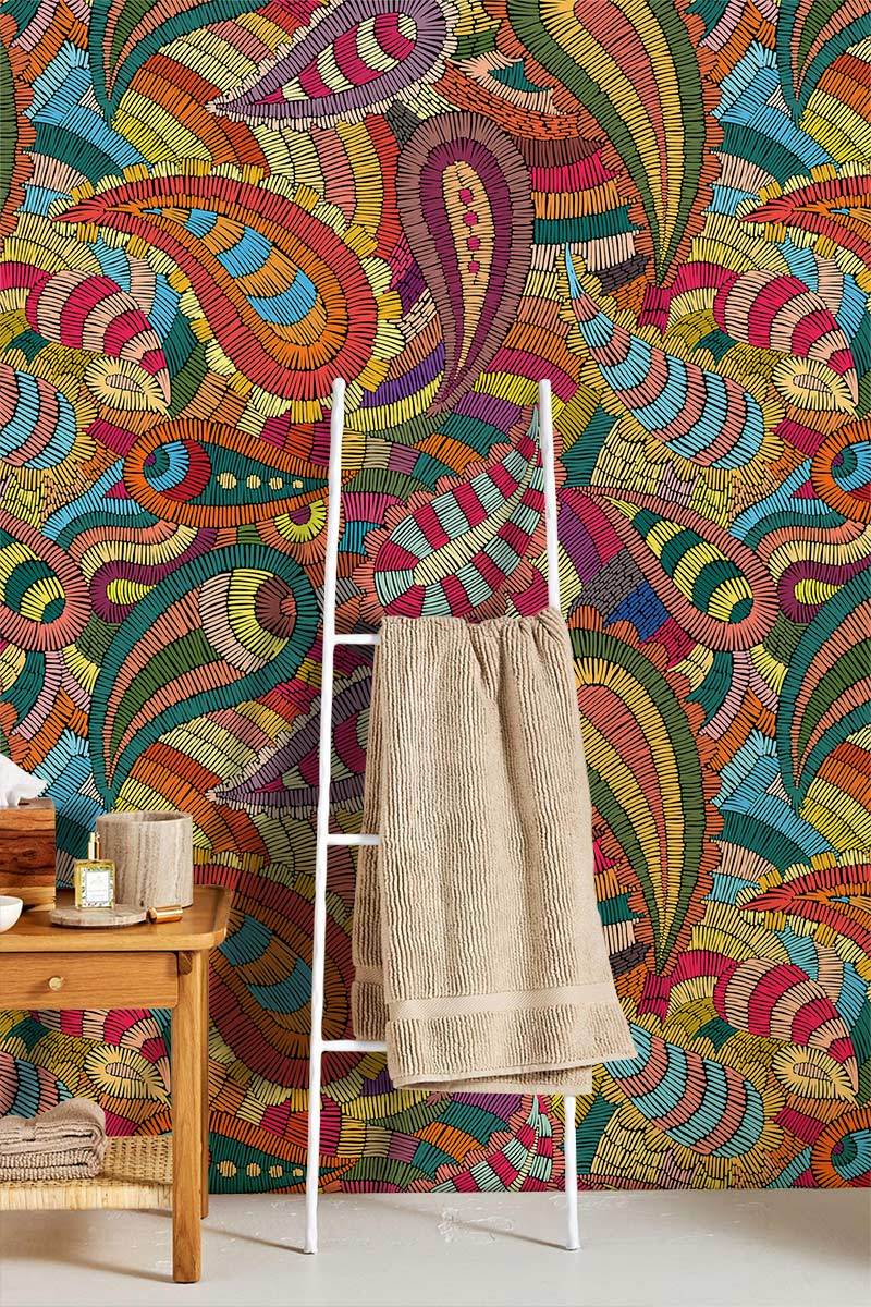 Vibrant Paisley Mosaic Wallpaper enhances bohemian decor with wooden furniture and neutral towel ladder.
