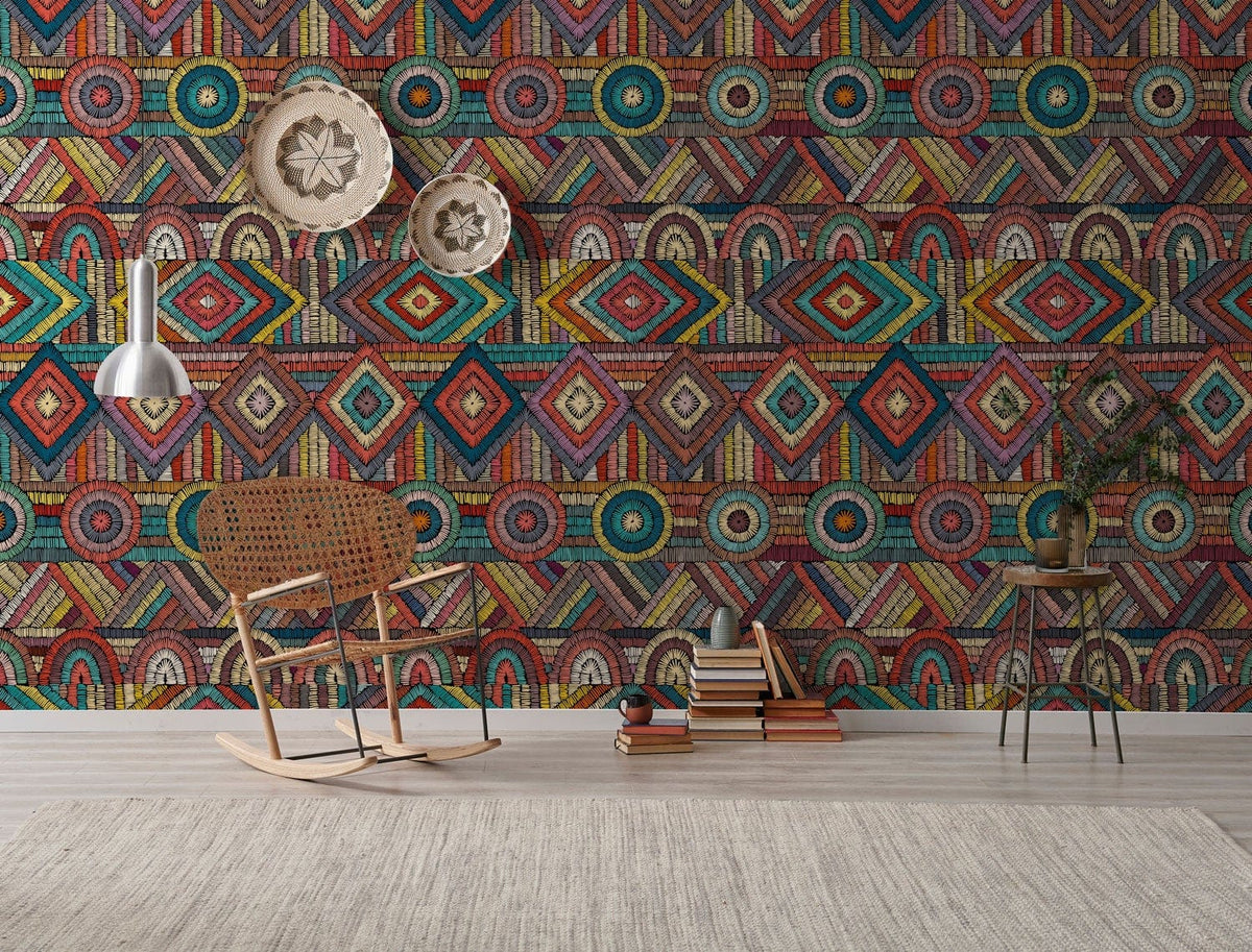 Multicoloured geometric wallpaper with tribal style, featuring wicker chair, light fixture, and wood flooring.