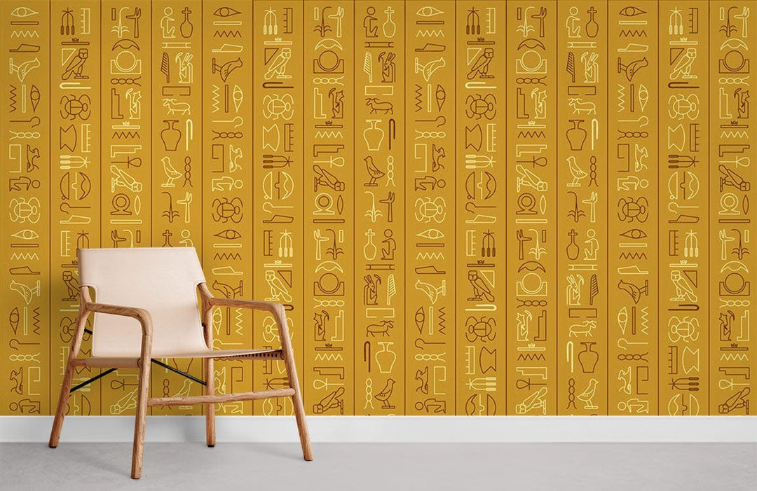 Ancient Egyptian gold hieroglyphics mural wallpaper with beige chair, grey flooring in stylish room.