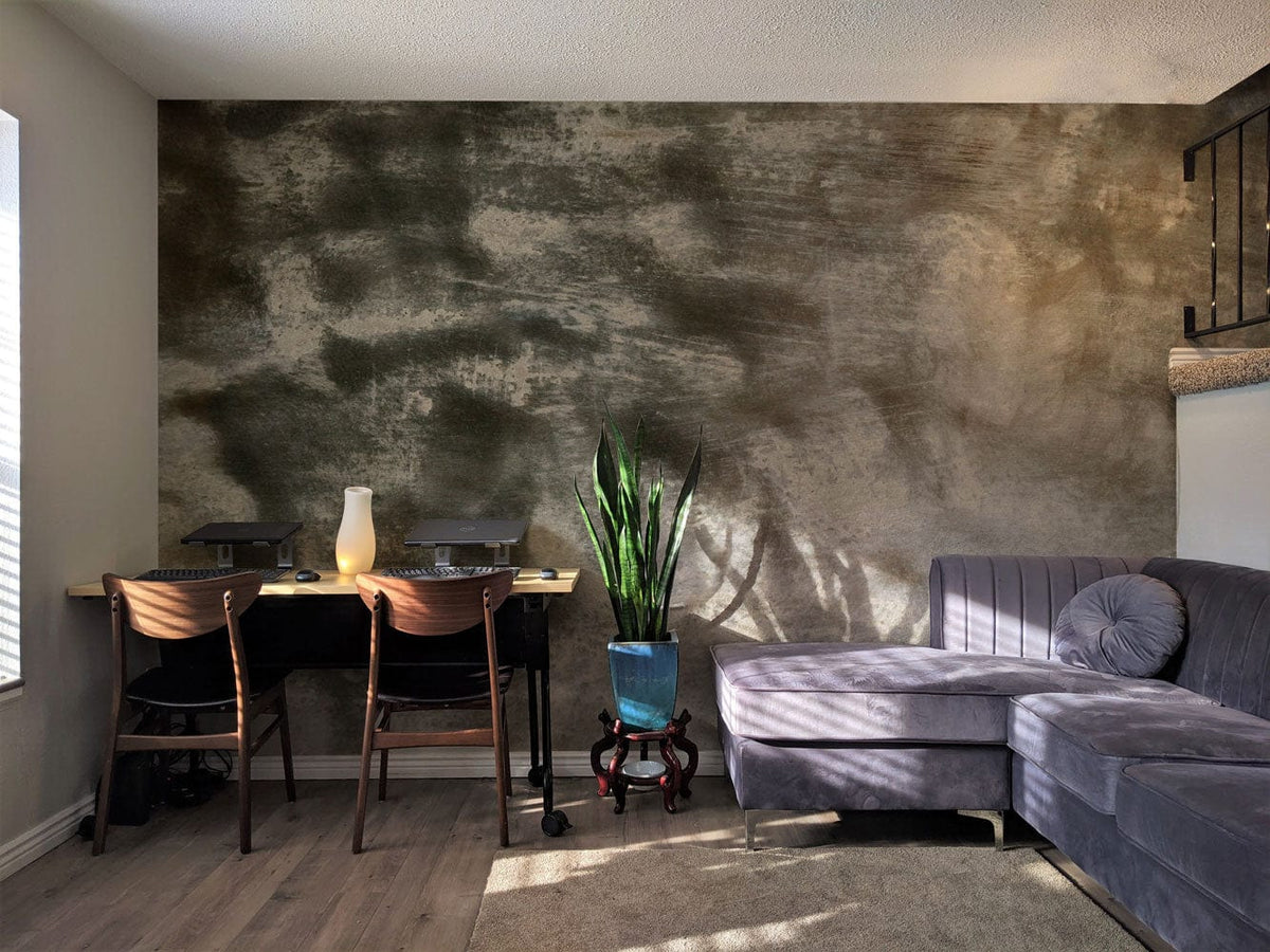 Abstract misty grey mural wallpaper with grey sofa, wooden chairs, and plant in stylish living room.