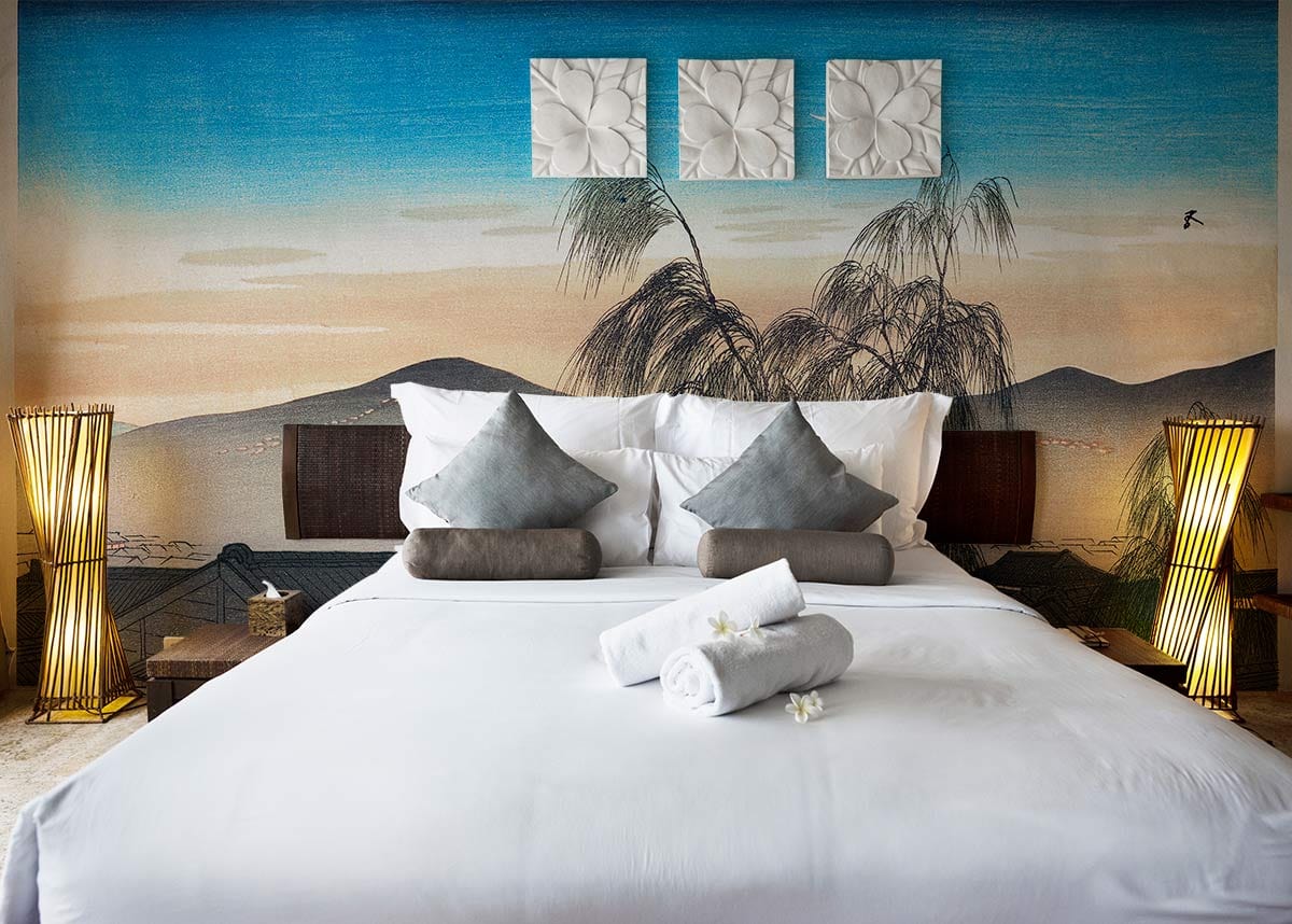 Contemporary bedroom with Elegant Japanese Dusk Mural Wallpaper, white bedding, Asian lamps, and minimal decor.