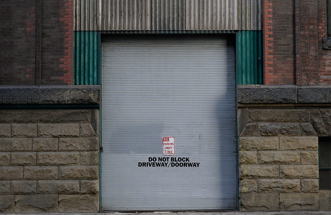 Industrial Urban Grey Stone and Metal Doorway Mural Wallpaper Design