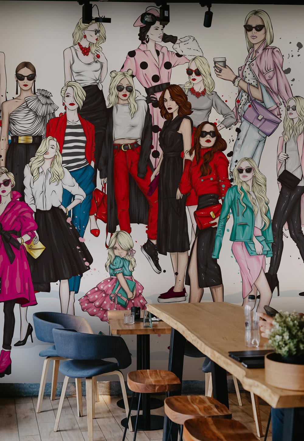 Chic Fashionista mural wallpaper featuring stylish illustration; modern dining chairs and wooden table complement.