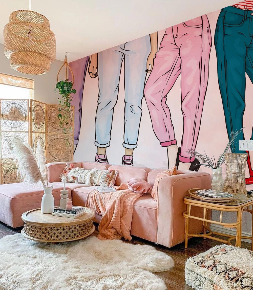 Bold Fashionista Jeans Mural Wallpaper in living room with pink sofa, wooden flooring, boho decor elements.