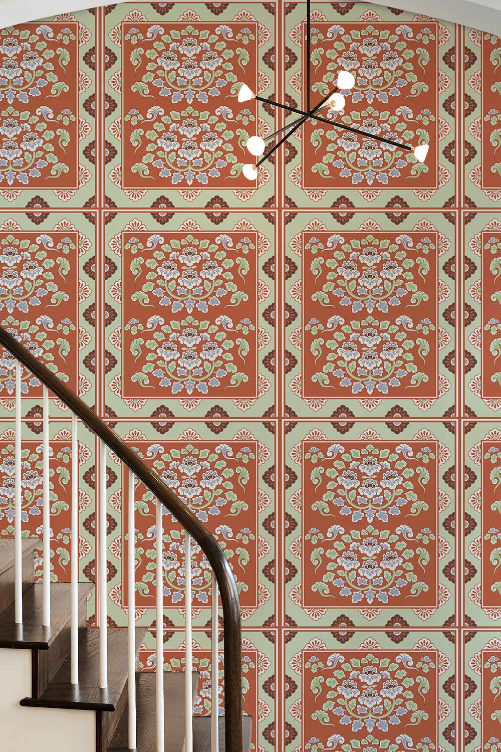 Retro vintage orange and cream floral wallpaper, chic Décor, modern chandelier, wooden staircase.