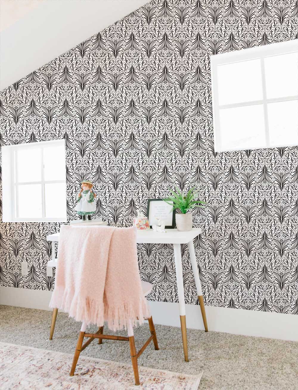 Elegant Monochrome Art Deco wallpaper in cosy room with white desk, pink throw, and textured carpet.
