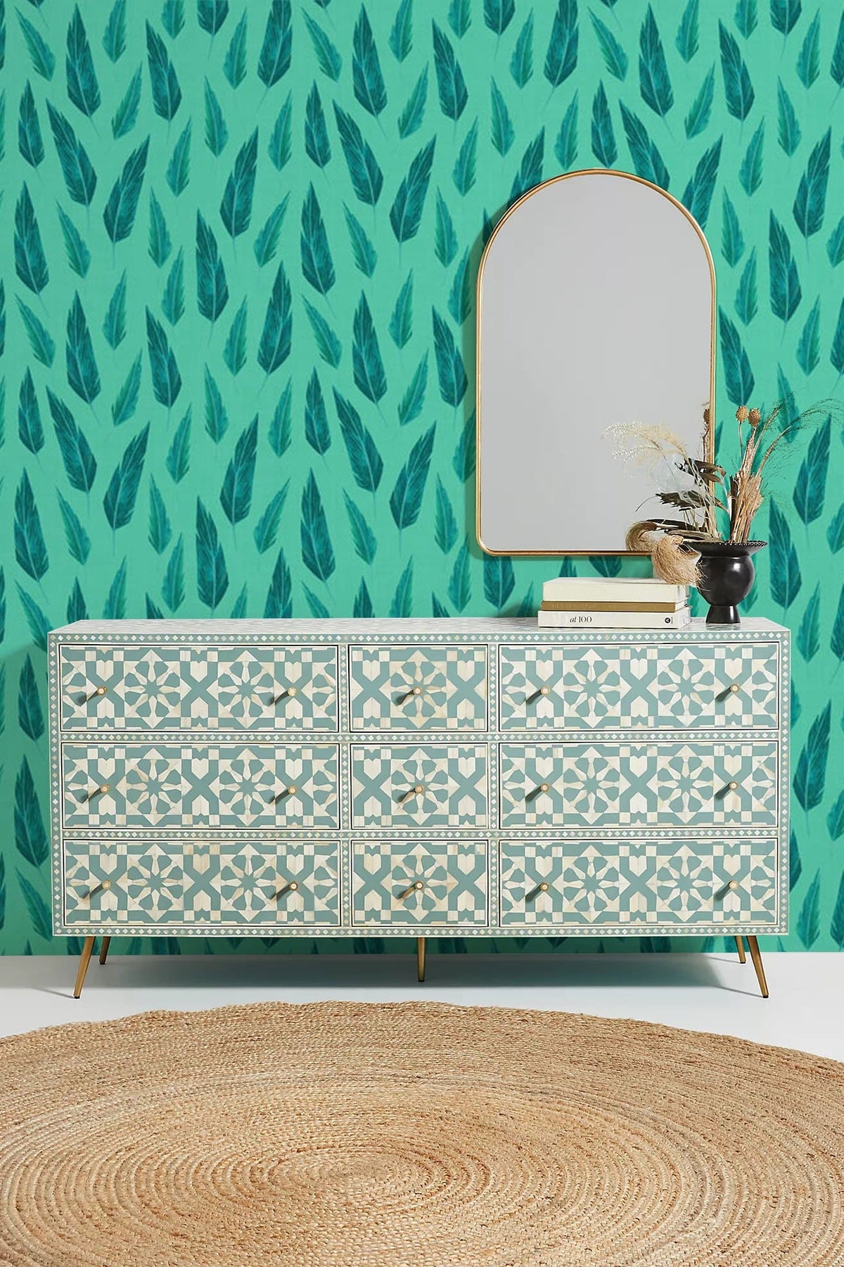 Aqua Teal Leaf Pattern Wallpaper in living room with ornate sideboard, mirror, and woven rug.