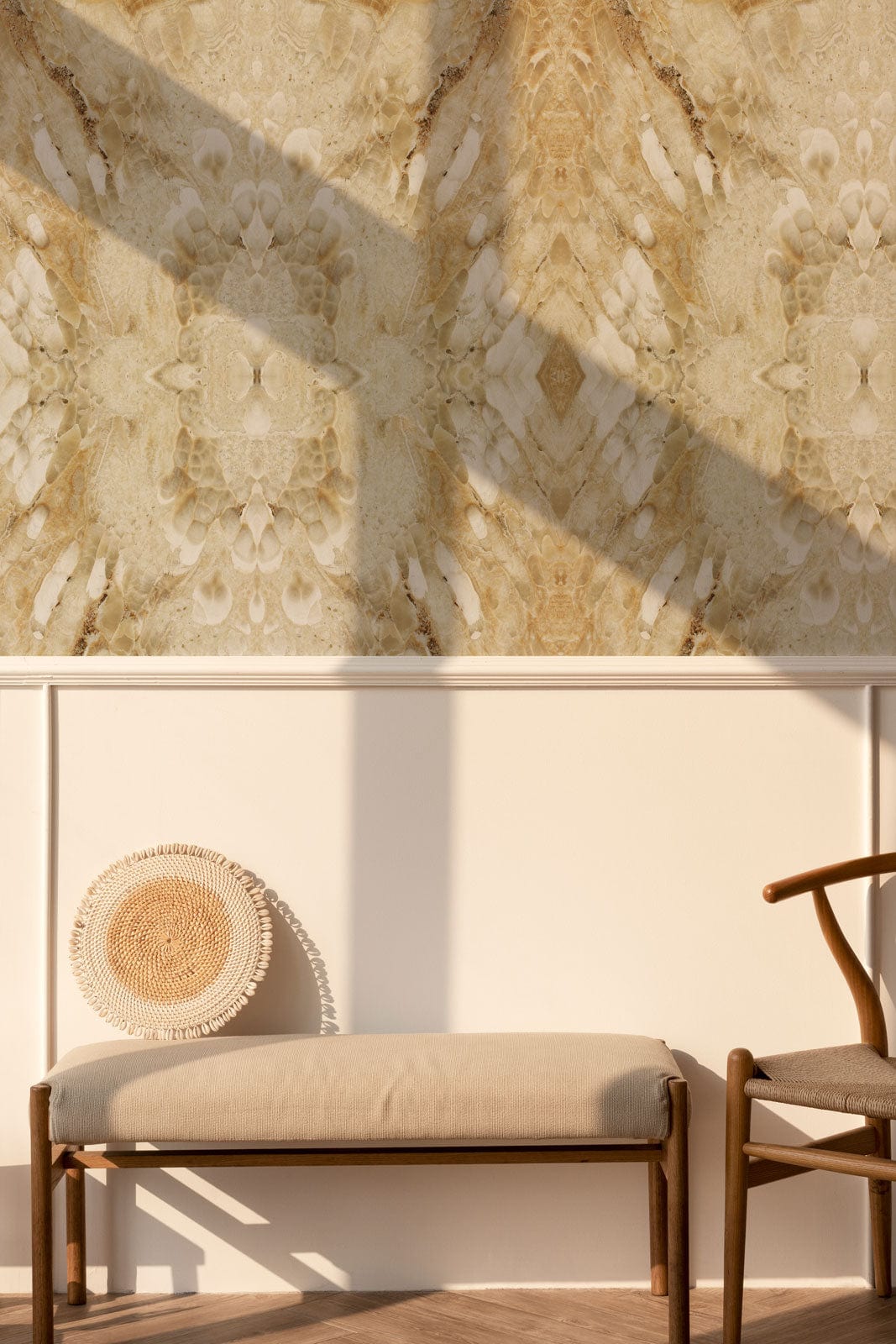 Elegant beige marble mural wallpaper, modern interior, light wood bench, neutral tones, stylish chair, shadow.