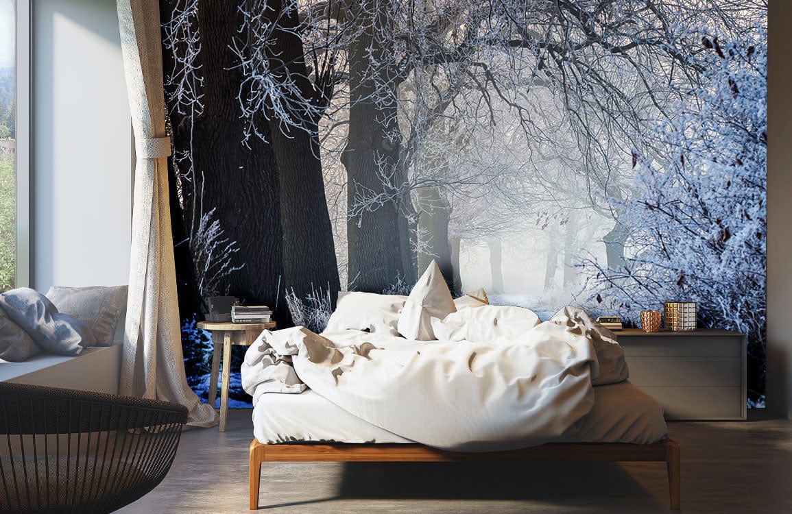 Winter Frost Enchanted Forest Mural Wallpaper in bedroom; wooden bed, grey sofa, light wood flooring.