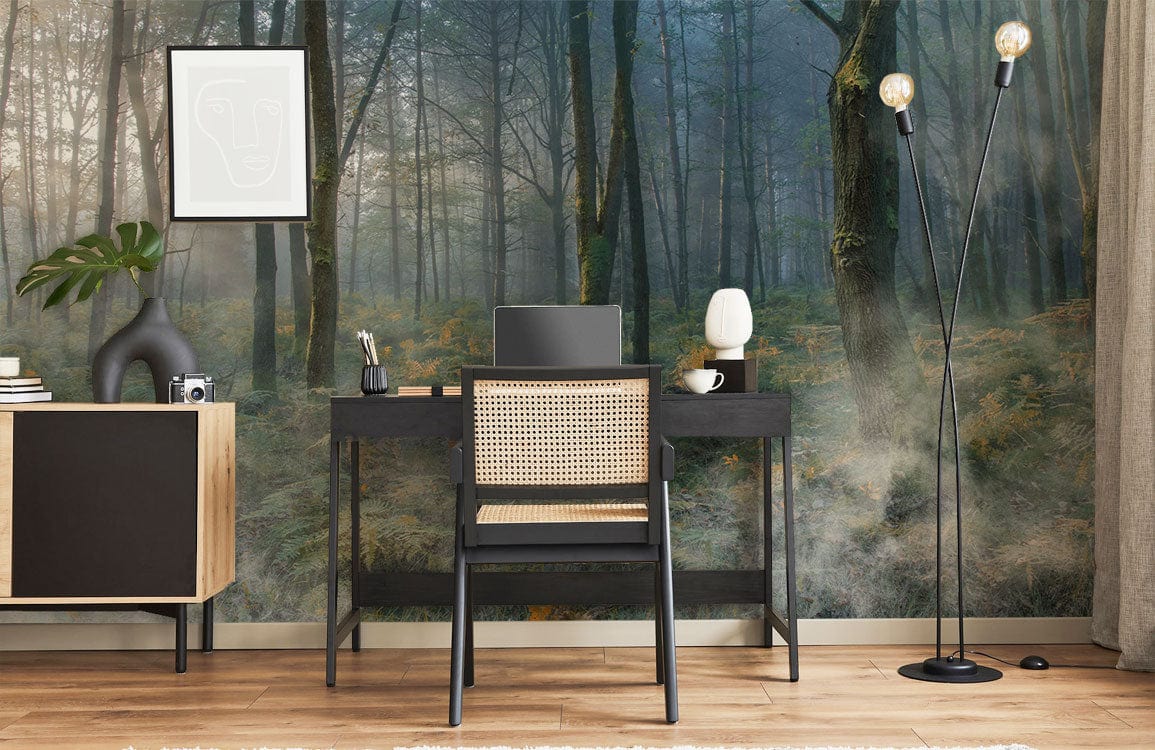 Enchanted Misty Woodland Forest Mural Wallpaper in serene green with black desk, chair, and floor lamp.