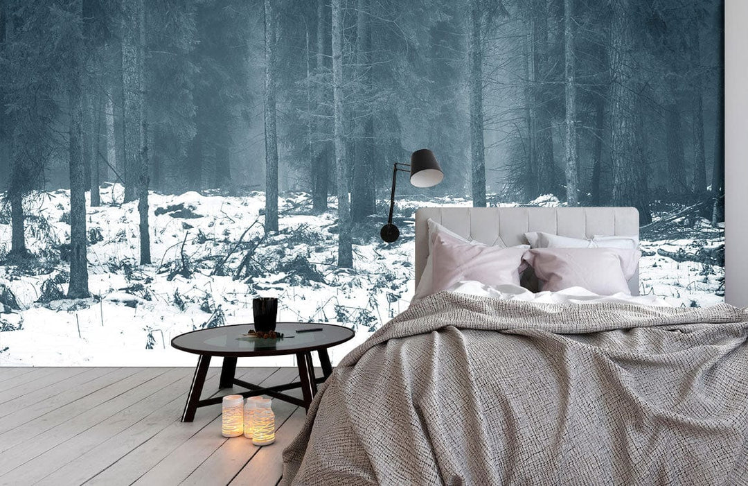 Enchanted Winter Forest Mural Wallpaper in bedroom with grey bed, wooden flooring, and round table.
