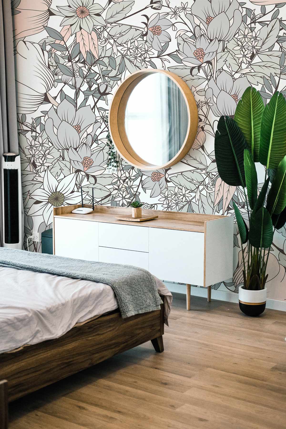 Elegant pastel floral wallpaper with wooden mirror, white console, modern bed, and neutral wood flooring.