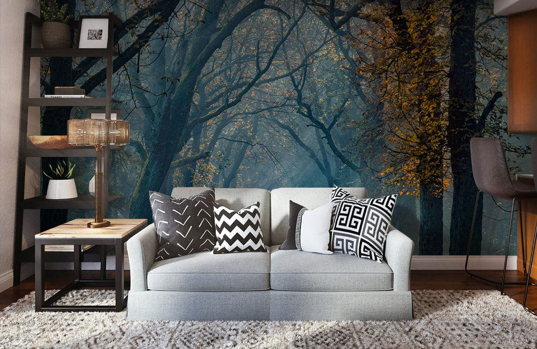 Mystical woodland mural with grey sofa, wooden flooring, bookshelf, and patterned cushions in living room.