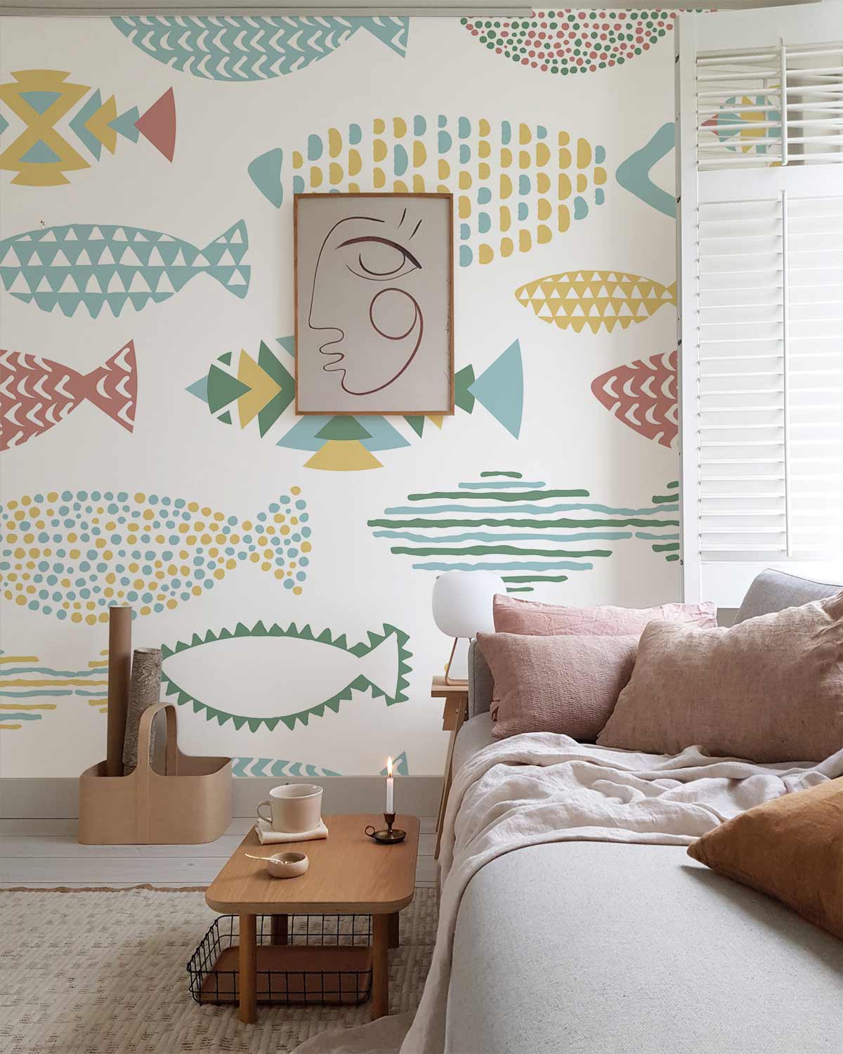Colourful Geometric Fish Pattern Wallpaper in modern coastal living room with grey sofa and wooden table.