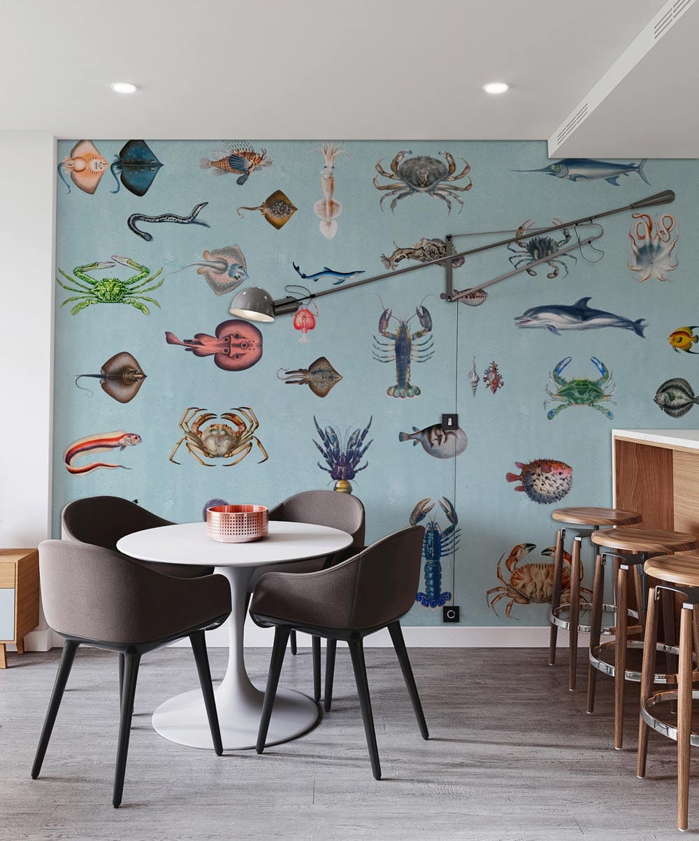 Vintage marine wallpaper featuring ocean creatures in dining area with grey chairs, wood flooring, bar stools.