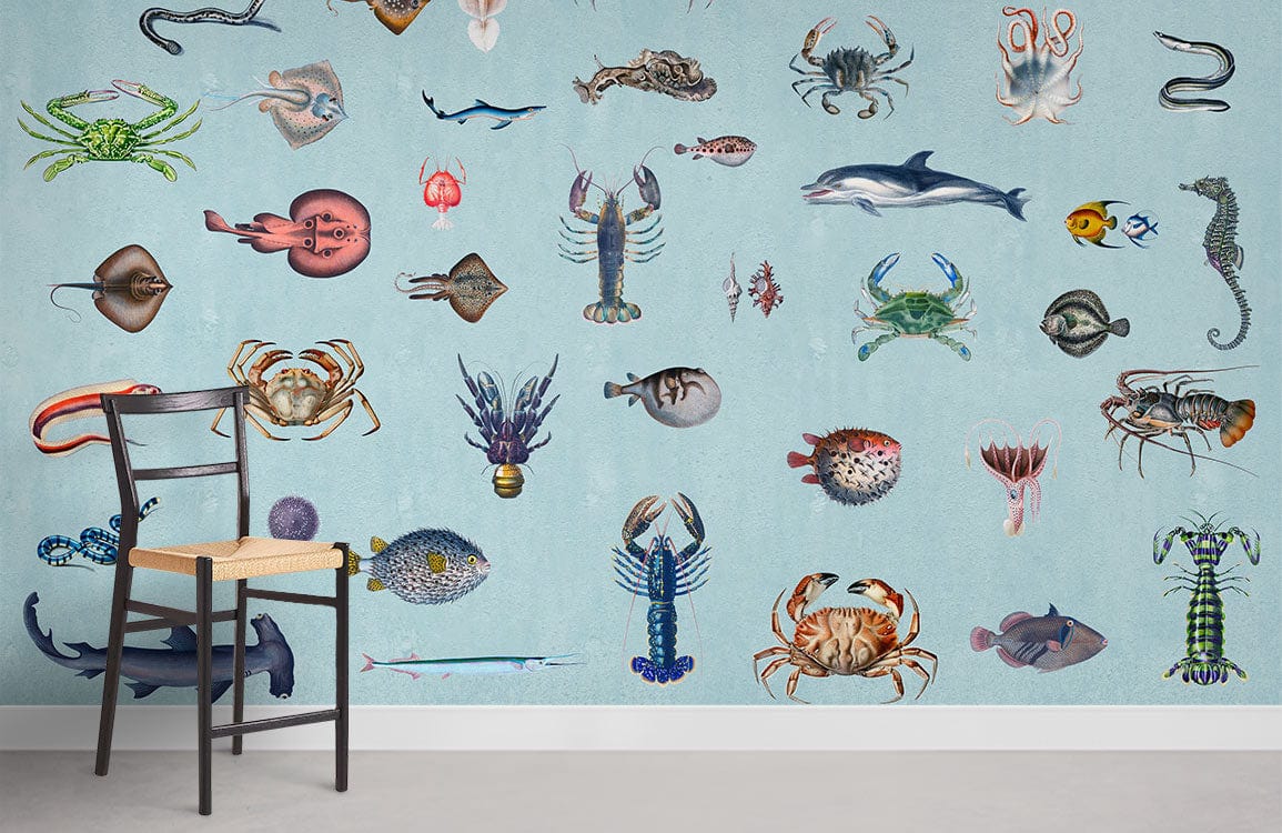 Vintage Blue Ocean Creatures mural wallpaper with chair; marine life pattern decor on light blue wall.