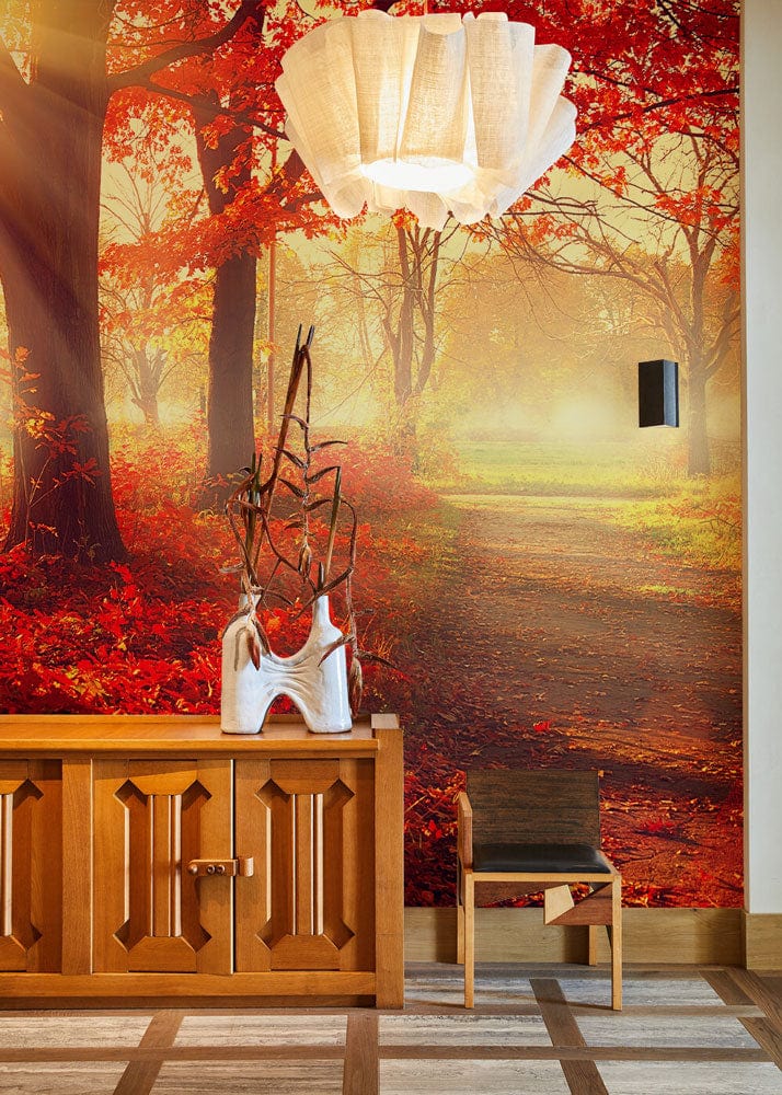 Autumnal forest mural wallpaper, vibrant red foliage, wooden sideboard, modern chair, unique ceiling light.
