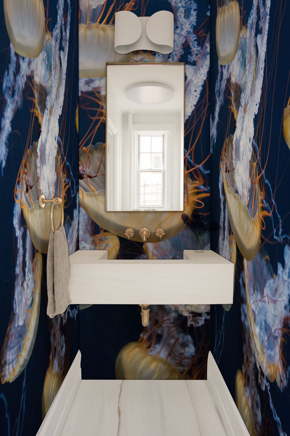 Deep Blue Ocean Jellyfish Wallpaper in nautical bathroom with white basin and marble flooring.