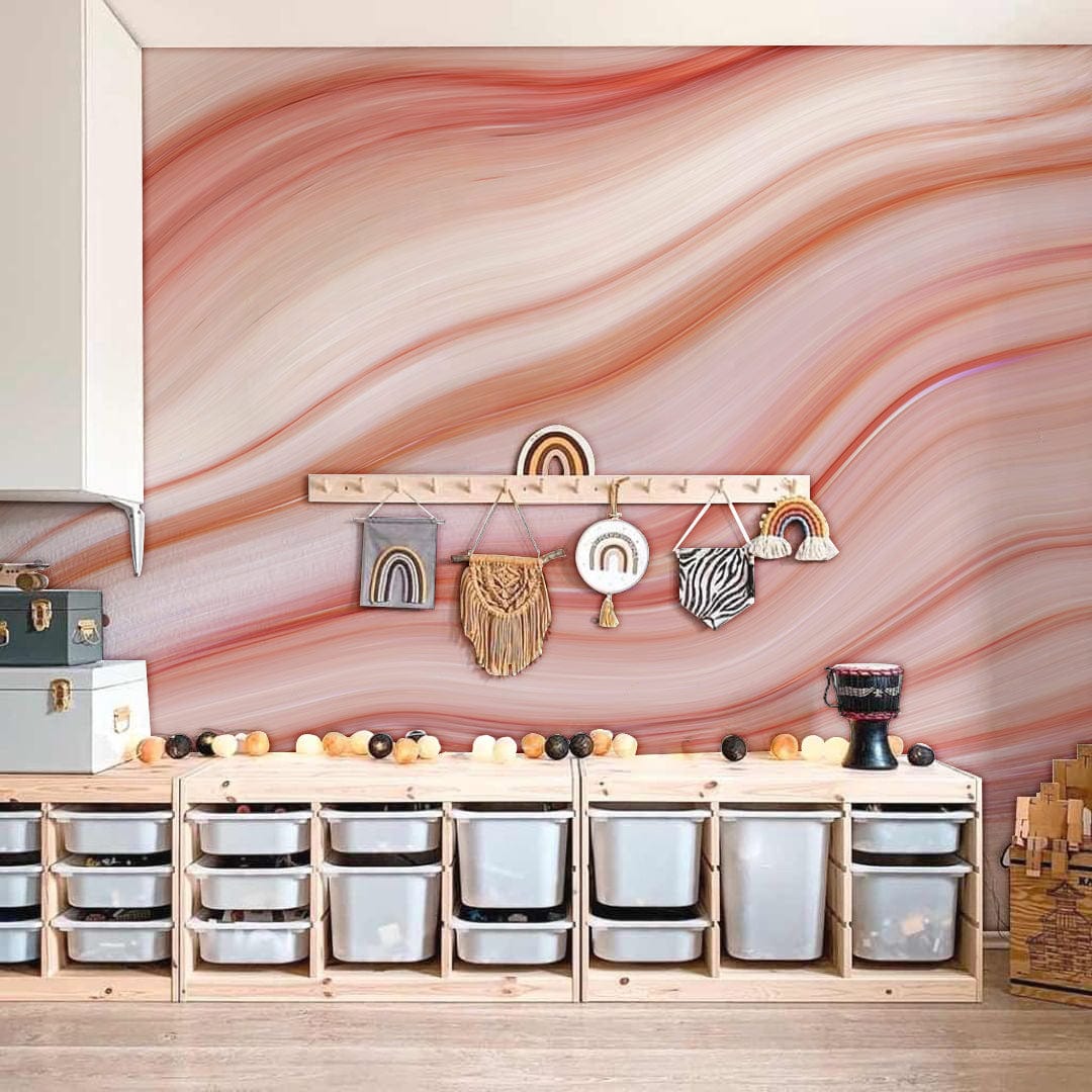 Elegant pink marble wave mural wallpaper in kids' room, with wooden storage units and neutral flooring.