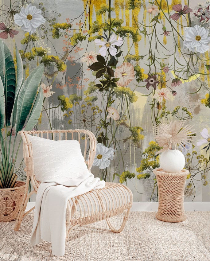 Elegant floral mural wallpaper in pastels, wicker chair, neutral rug, tropical leaves, airy room design.
