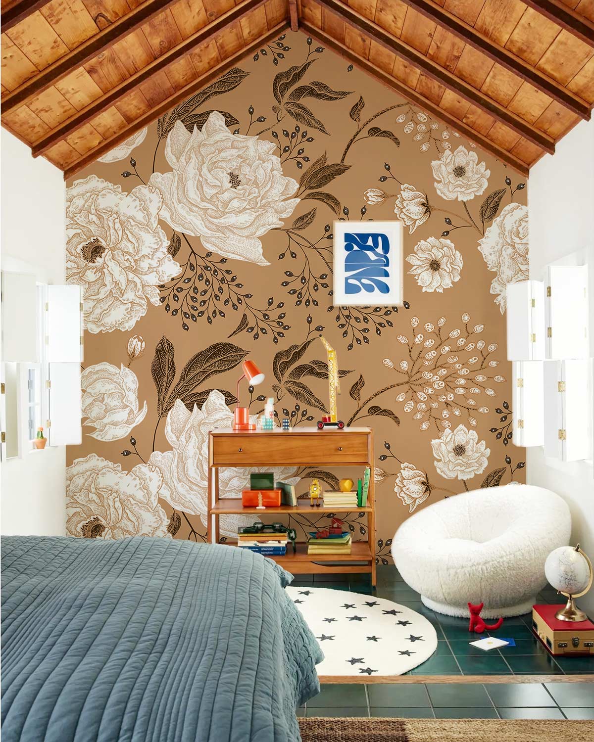 Vintage floral wallpaper with cream roses, wooden ceiling, plush chair, wooden cabinet, bedroom setting.