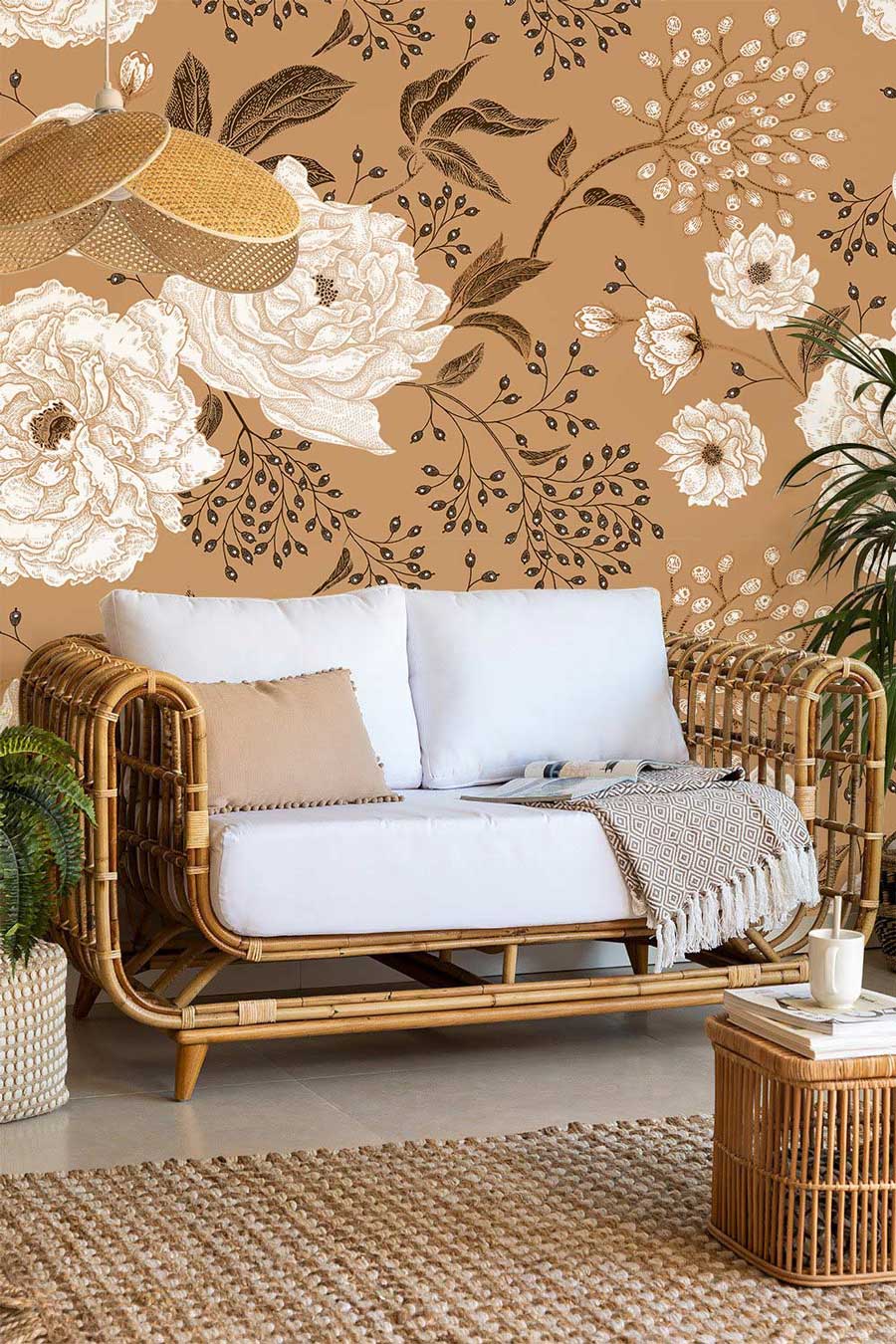 Vintage floral wallpaper in living room with cream roses, rattan sofa, warm brown background, rug.