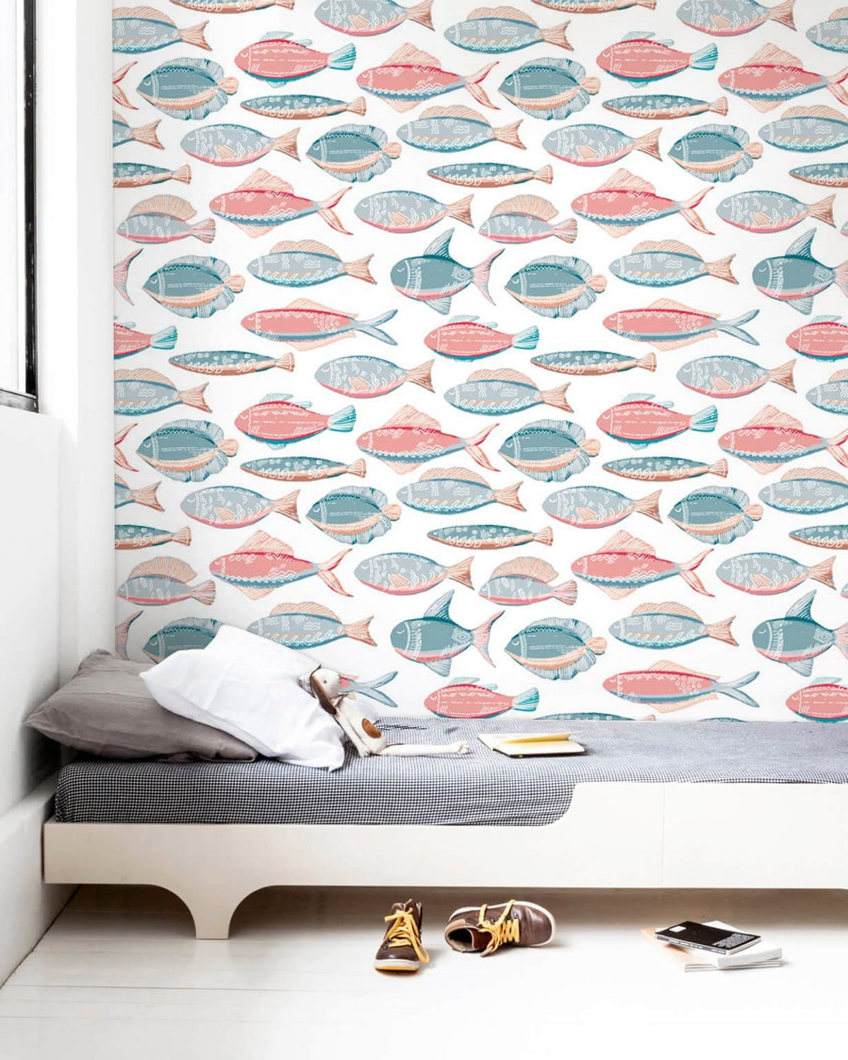 Coastal Coloured Fish Pattern Wallpaper in nautical themed bedroom with grey daybed, white walls.