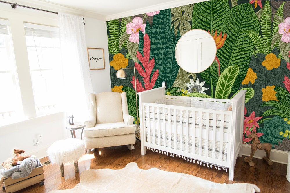 Tropical Paradise Botanical mural wallpaper, white nursery, wooden flooring, cream armchair, vibrant floral design.