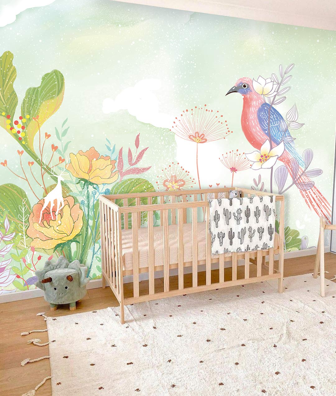 Nursery with Serene Pastel Garden Mural Wallpaper, exotic bird, floral design, wooden cot, decorative rug.