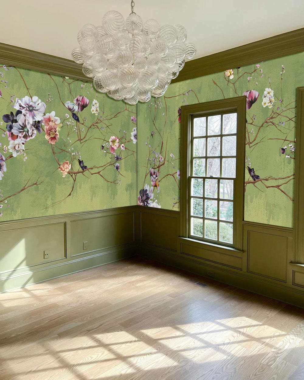 Elegant green floral mural wallpaper in traditional room with wooden flooring and vintage chandelier.