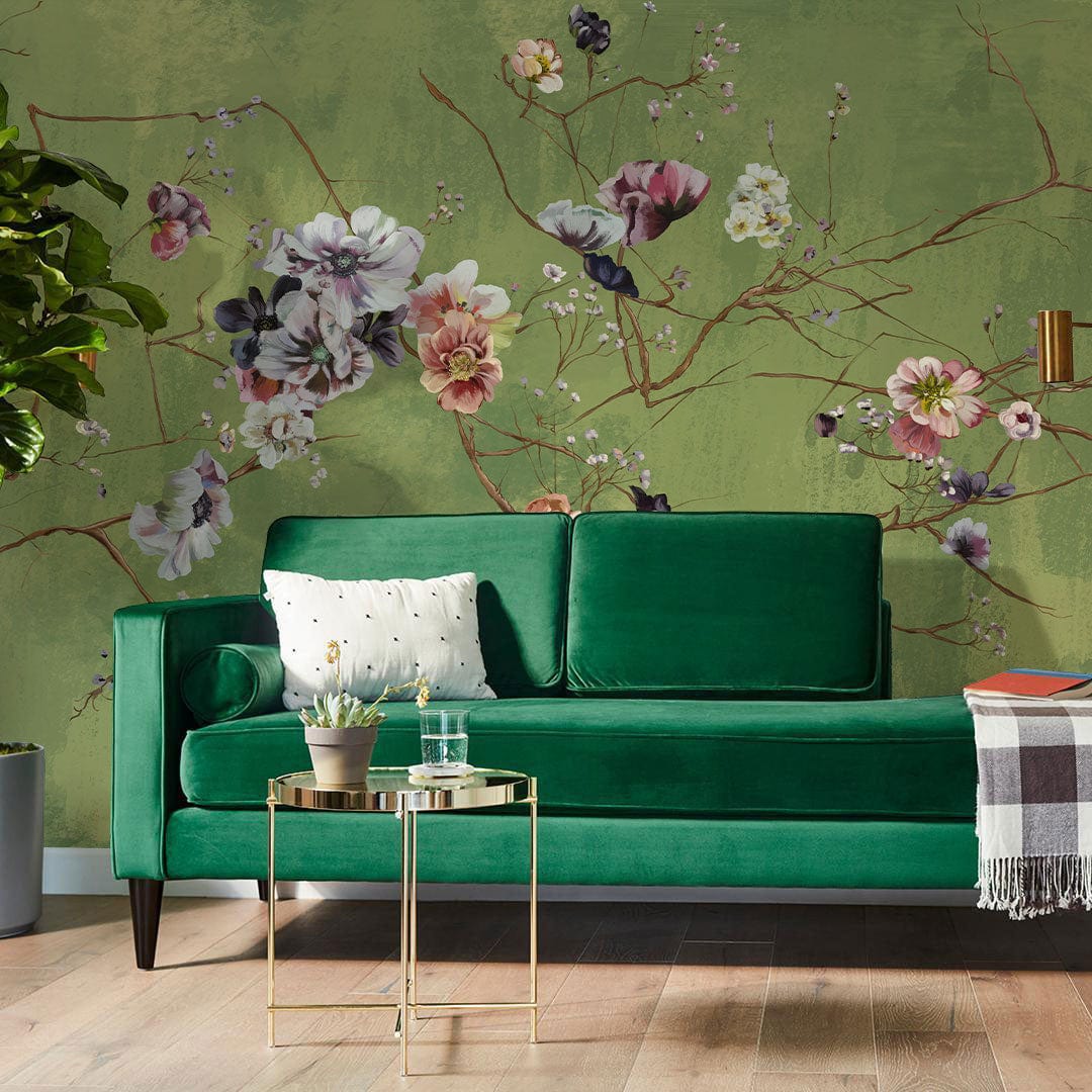 Elegant green floral mural wallpaper, vintage blossom pattern, green sofa, wood flooring, living room setting.