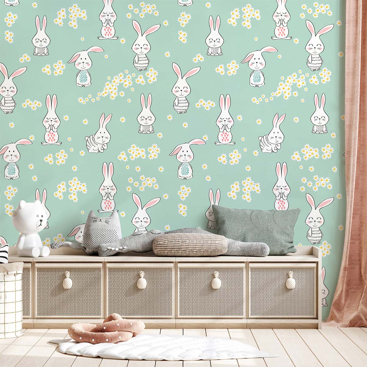 Pastel green bunny and daisy wallpaper mural in children's bedroom with plush toys, wicker storage.
