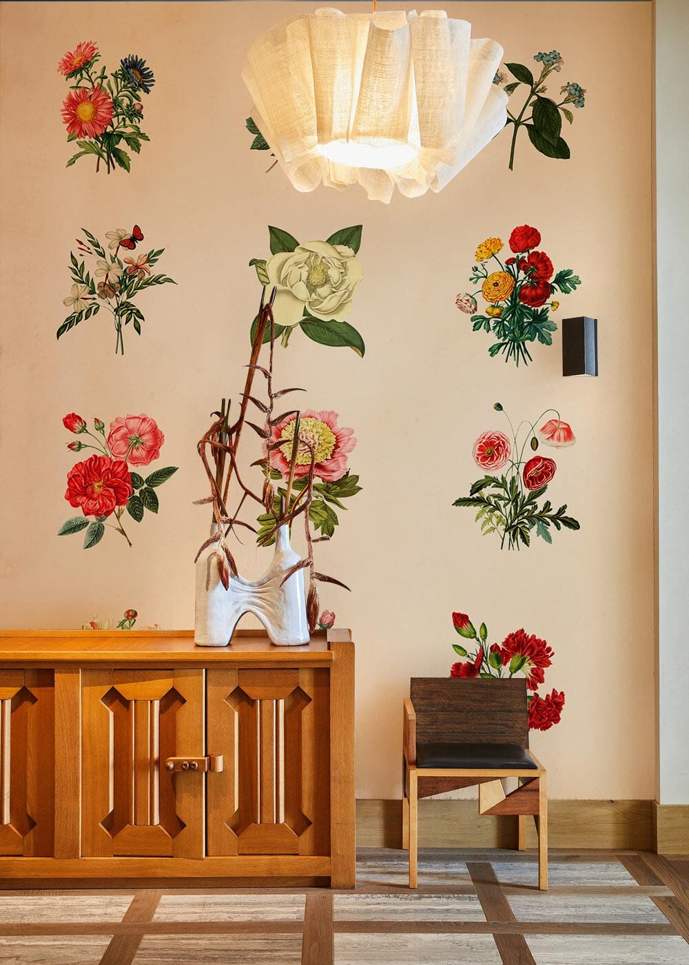 Vintage Floral Wallpaper in pastel tones, wooden cabinet, modern chair, and elegant pendant light.