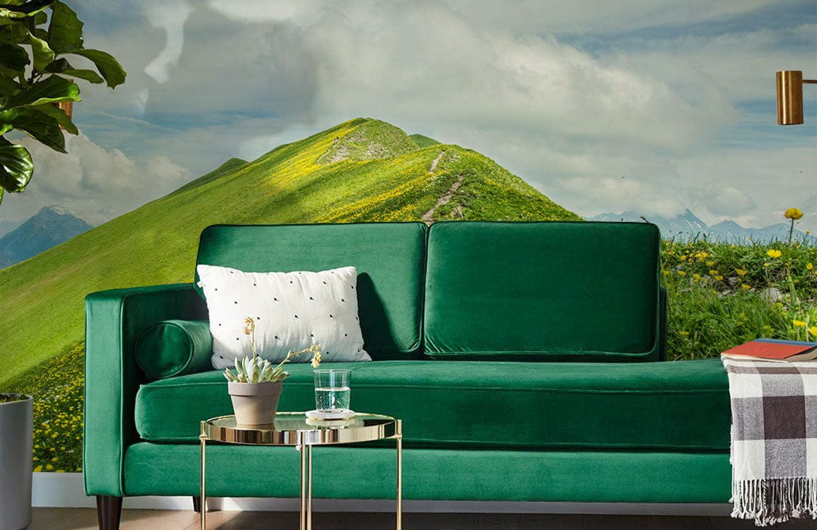 Green velvet sofa, Serene Green Mountain Pasture Mural Wallpaper, yellow wildflowers, gold side table, contemporary.