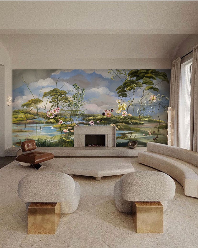 Pastoral Haven mural wallpaper in living room with beige sofa, armchairs, fireplace, and geometric rug.