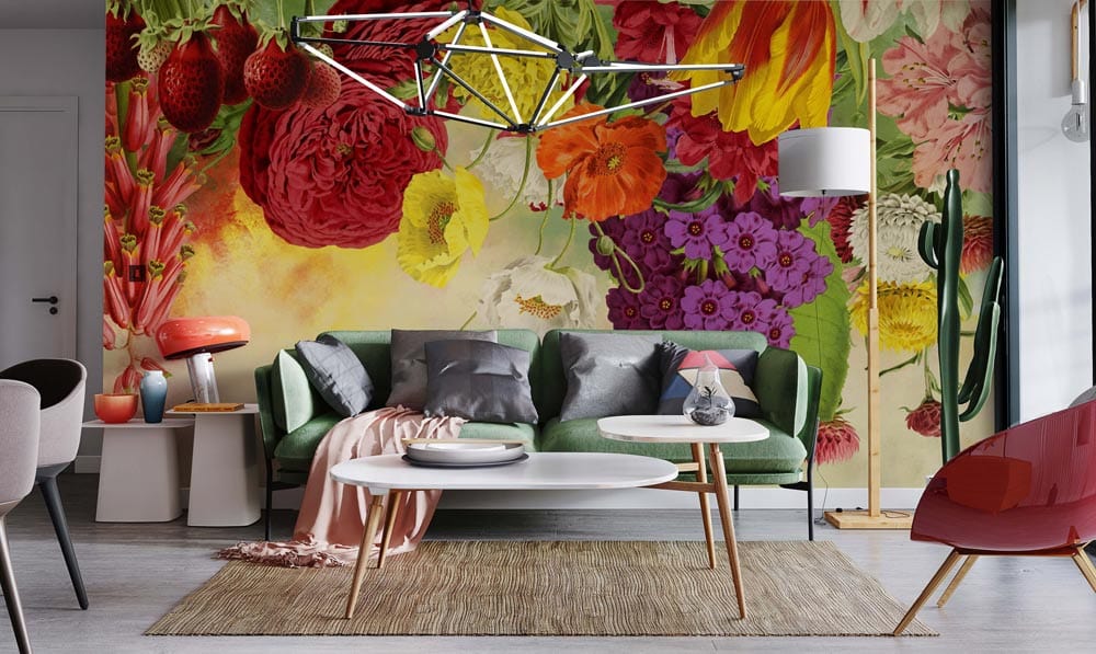Colourful Vintage Floral Mural Wallpaper in living room with green sofa, modern chandelier, wood flooring.