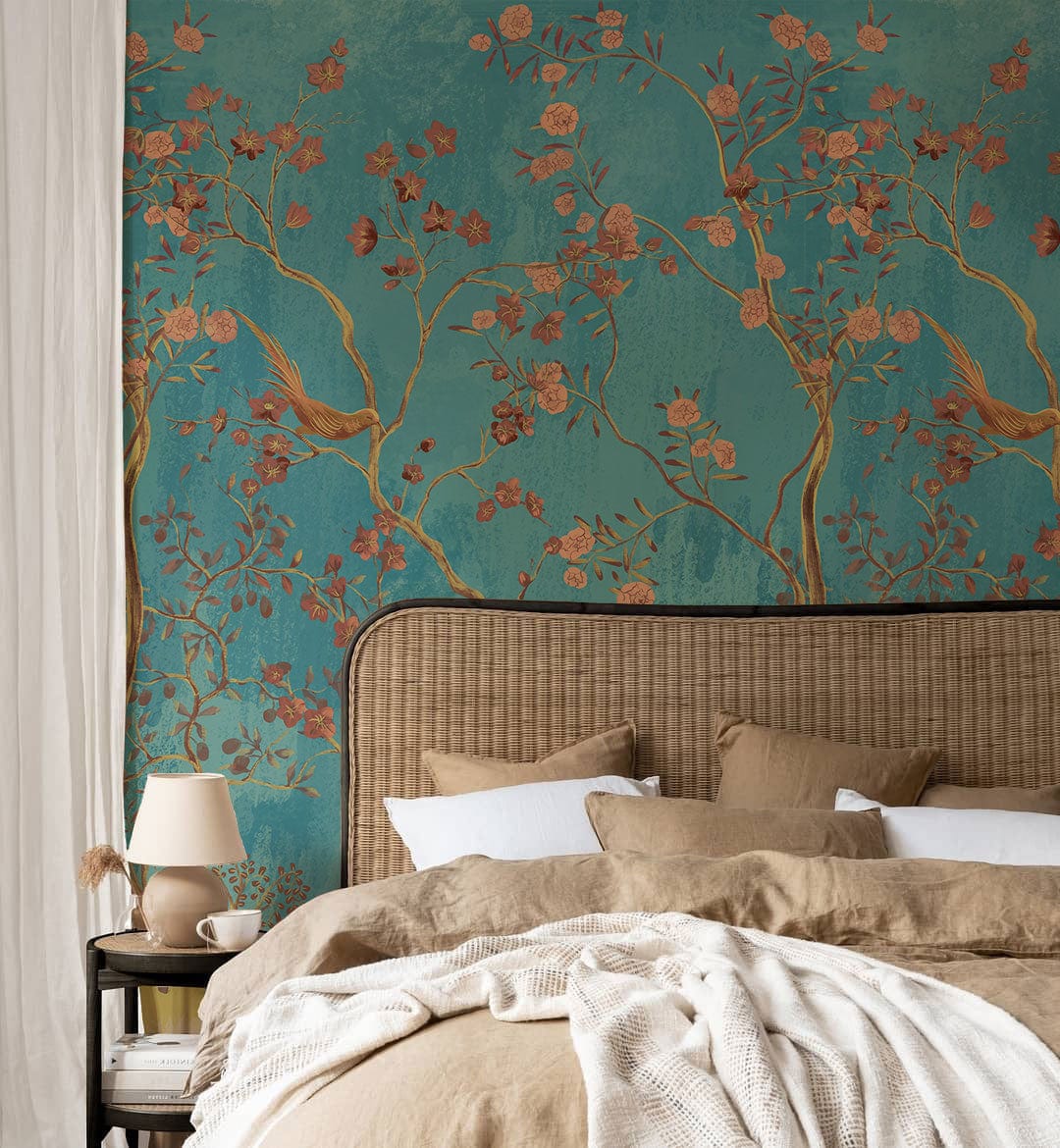 Elegant teal wallpaper with golden flora, birds motif behind beige headboard bed in cosy bedroom.