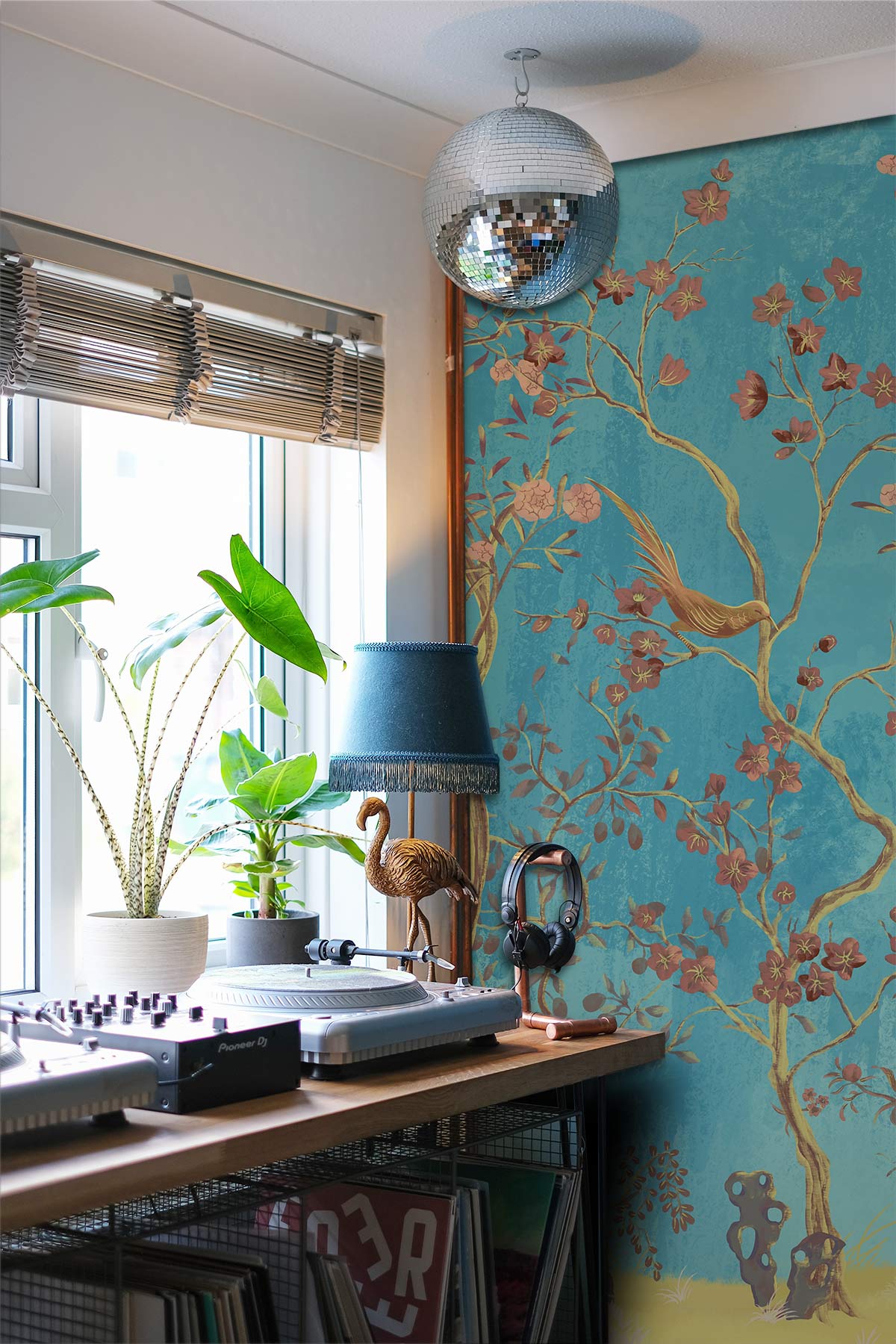 Elegant Teal Chinoiserie Wallpaper; golden birds motif; wooden table; turntables; teal lamp; home studio.