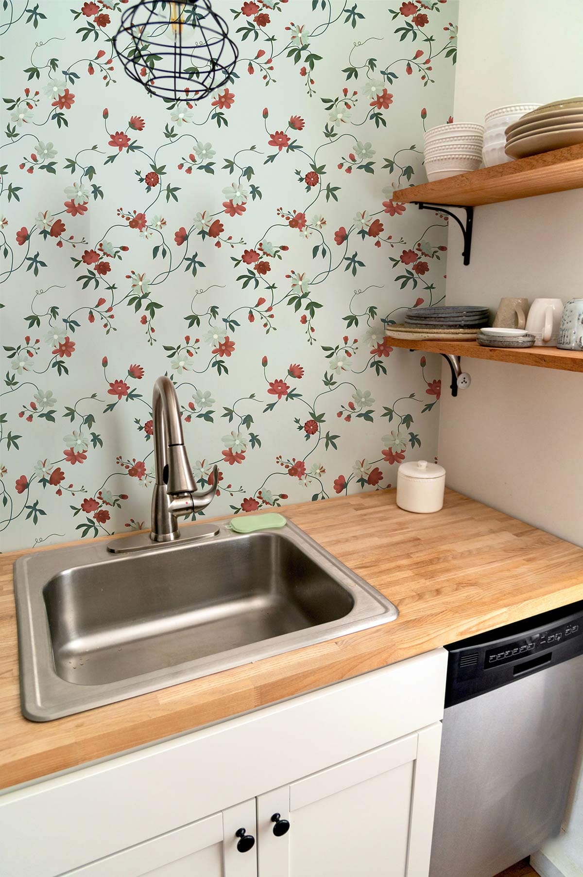 Cherry Blossom Elegance wallpaper in kitchen with floral pattern, wooden shelves, and stainless steel sink.
