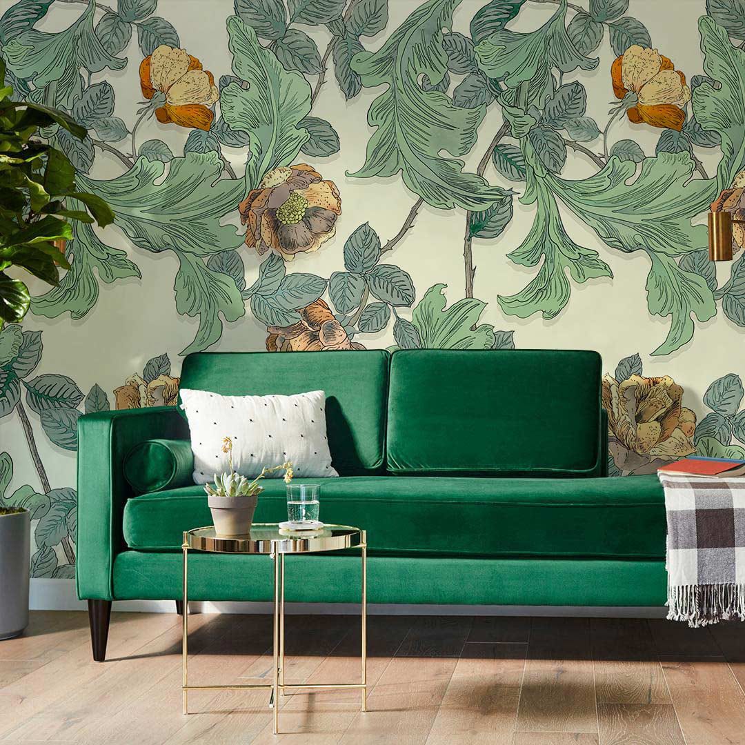 Vintage botanical mural wallpaper, green ochre tones, lush sofa, elegant side table, wood flooring.