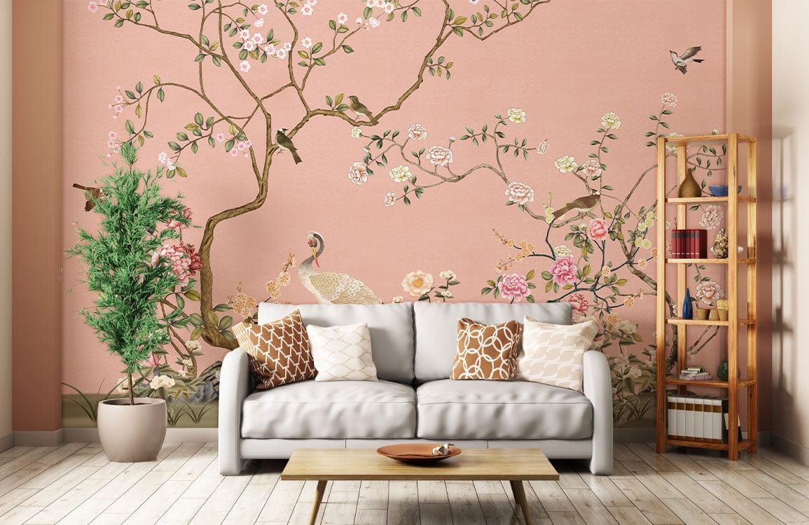 Elegant pastel Chinoiserie mural wallpaper with cranes, blossoms, grey sofa, wooden shelving, in lounge room.
