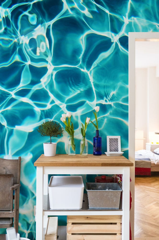 Turquoise Ripple Effect Aquatic Theme Wallpaper in interior with wooden furniture and parquet flooring.