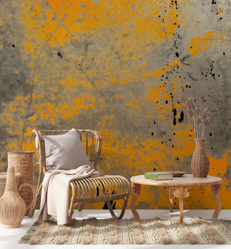 Industrial yellow and grey abstract mural wallpaper in modern living room with wicker furniture and rug.